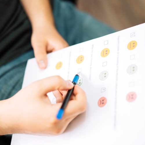 Man taking a psychological test with emoticons.